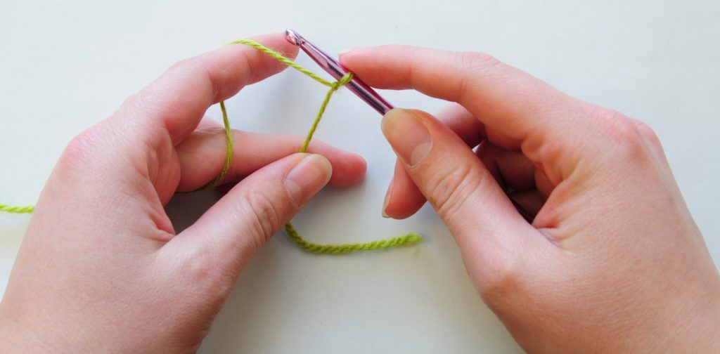 In the third lesson of Crochet basics we'll learn how to hold the hook two ways and how to wrap the yarn around your hand. Join us and learn how to crochet! | Nea Creates