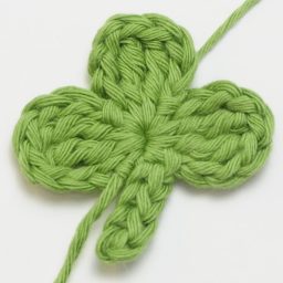 Crochet these super cute Clover Appliqués for Saint Patrick's Day using this quick and easy FREE crochet pattern! #fourleafclover #crochetclover #crochetfourleafclover #freecrochetpattern