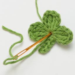 Crochet these super cute Clover Appliqués for Saint Patrick's Day using this quick and easy FREE crochet pattern! #fourleafclover #crochetclover #crochetfourleafclover #freecrochetpattern